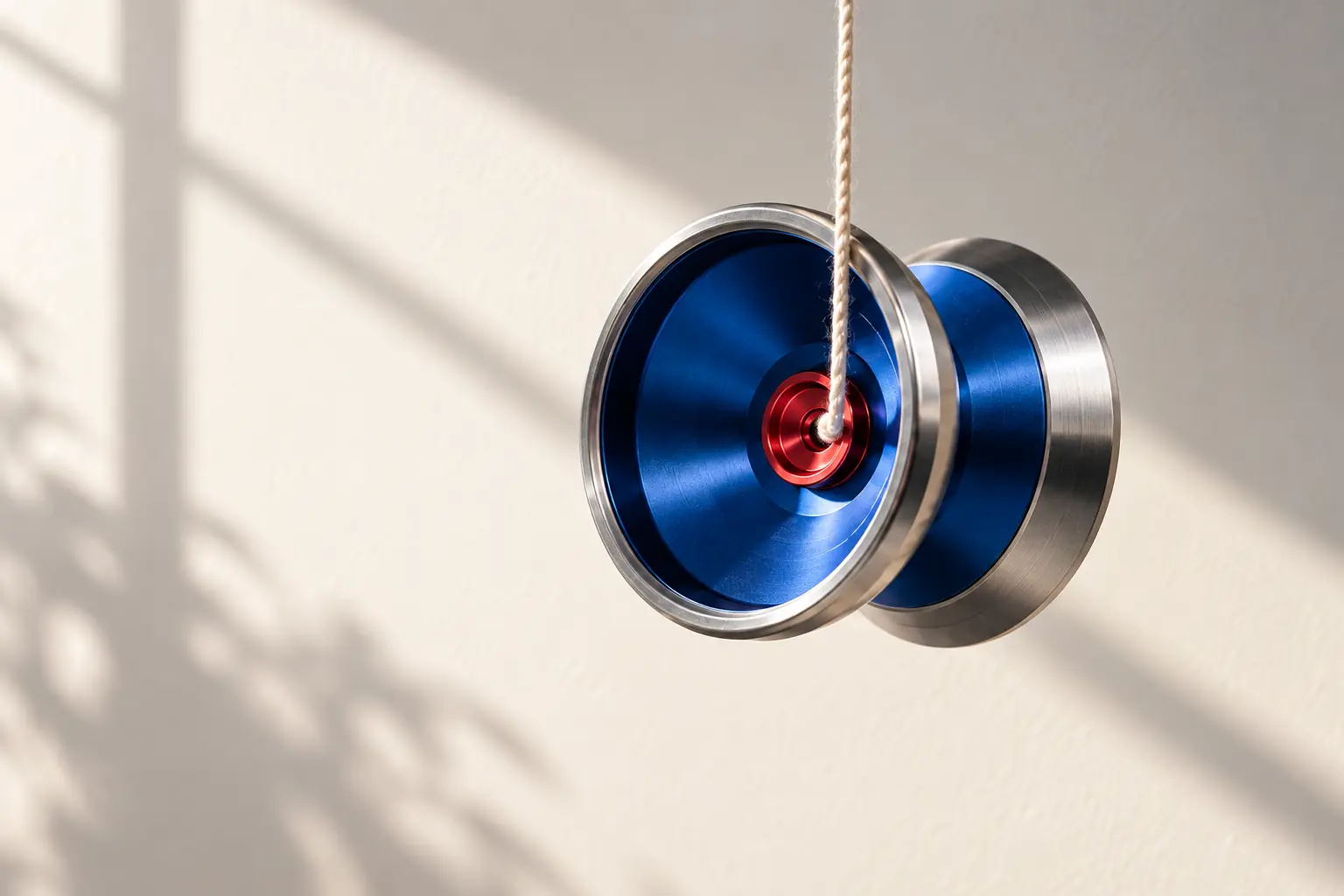 A modern metal yo-yo in architectural light.